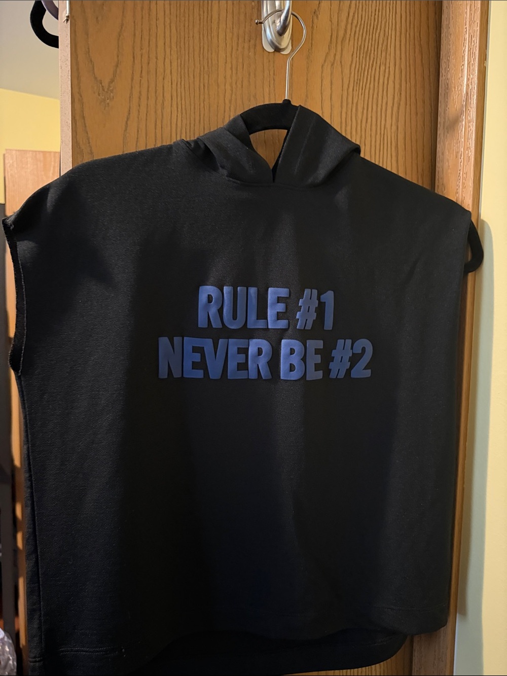 Black Sleeveless Hoodie with "Rule #1 Never Be #2" Blue Graphic